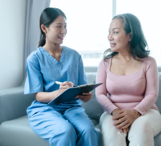 aide and senior woman having a conversation